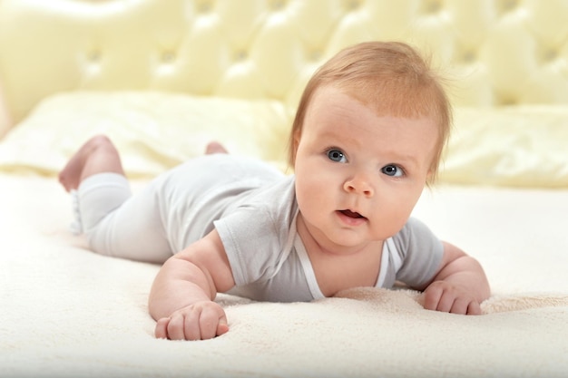 Cute little baby girl on bed