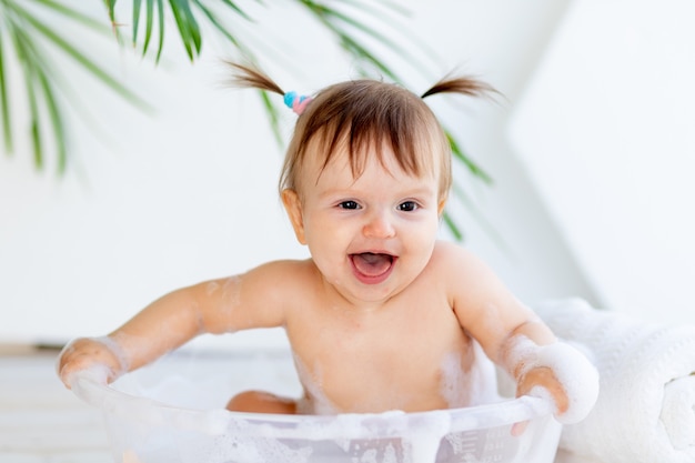 Cute little baby girl taking a bath