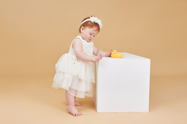 Cute little baby girl in a white dress