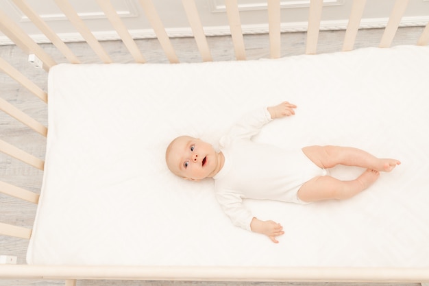 Cute little baby sitting in bed