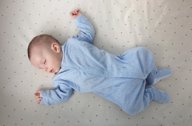 Cute little baby sleeping on bed at home