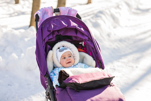 Cute little baby in a stroller outdoor.