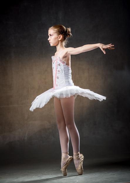 Cute little ballerina dancing in studio