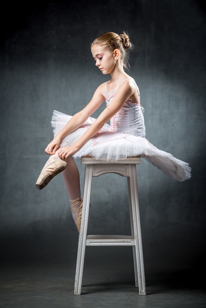 Cute little ballerina dancing in studio