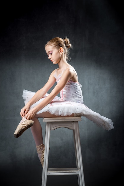 Cute little ballerina dancing in studio