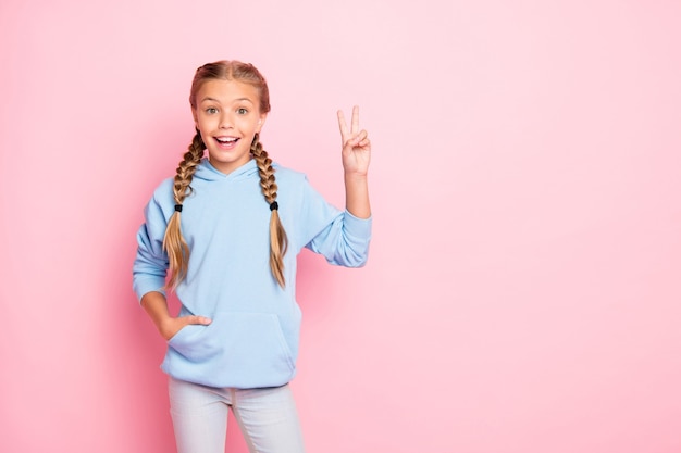 Cute little blonde girl in a blue sweater