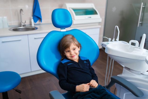 Cute little boy and dentist in clinic