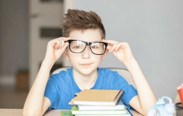 Cute little boy doing homework. Child learning foe school.