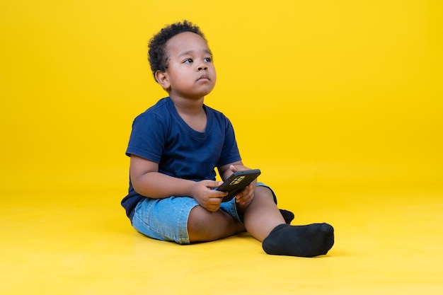 Cute little boy learning internet or playing games with tablet