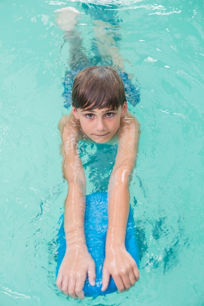 Cute little boy learning to swim