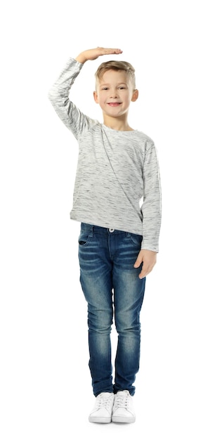 Cute little boy measuring height on white background