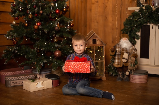 Cute little boy near Christmas tree