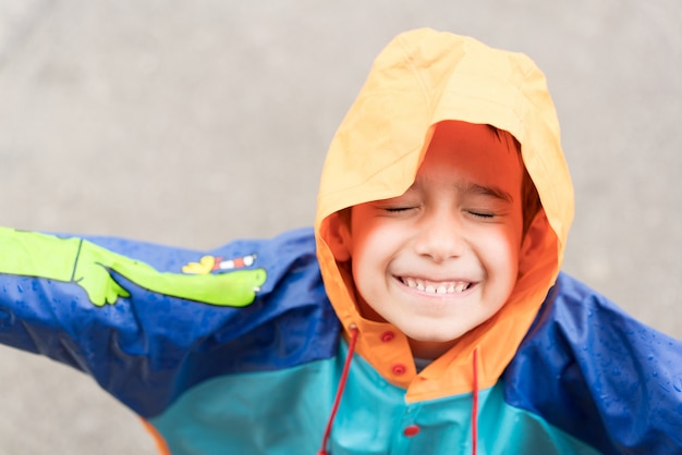 Cute little boy out for tasting rain