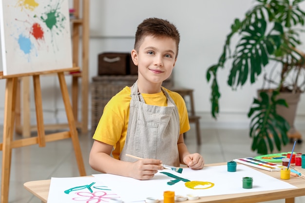 Cute little boy painting at home