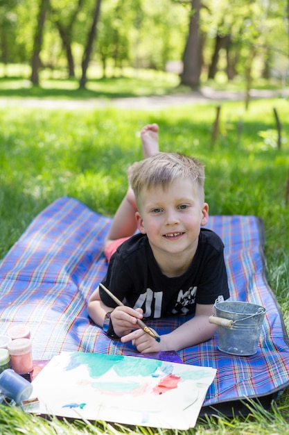 Cute little boy painting picture