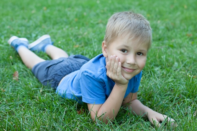 Cute little boy playing in the green park