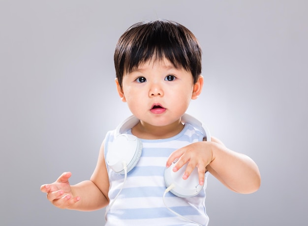 可愛い小さな男の子が肩にヘッドセットをかけました