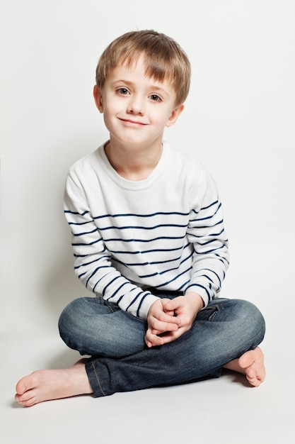 Cute little boy sitting on the floor