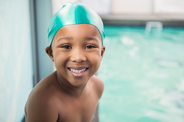 Cute little boy smiling at the pool