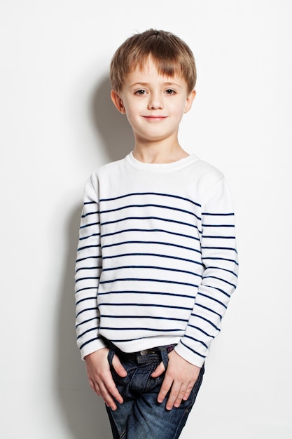 Cute little boy standing on background