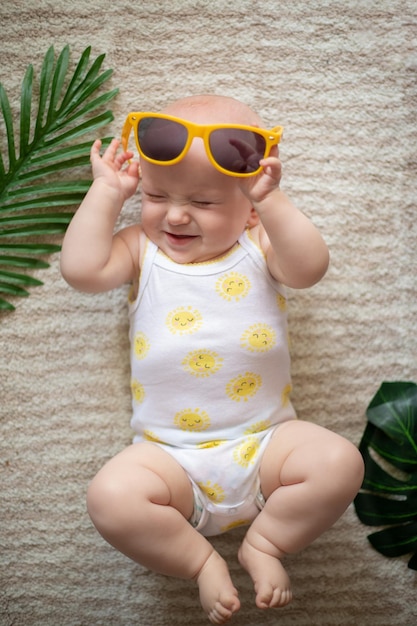 Cute little boy in sunglasses at home