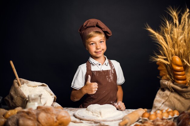 Cute little boy with chef hat cooking