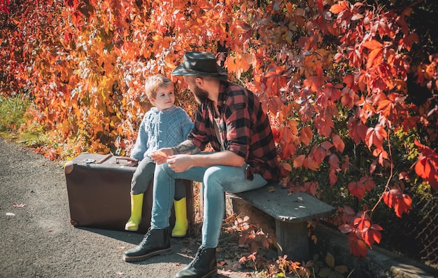 Cute little boy with his father during stroll in the forest