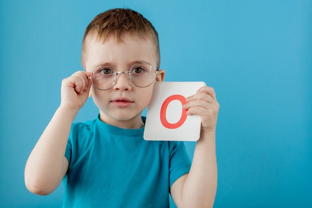 Cute little boy with letter. Child learning a letters. Alphabet