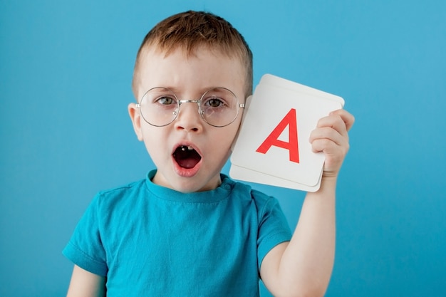 Cute little boy with letter. Child learning a letters. Alphabet