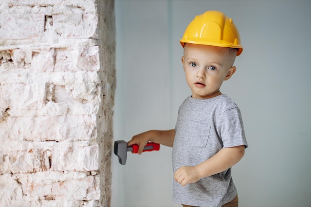 Cute little boy with toy building tools