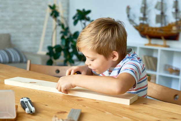 Cute Little Boy Working with Wood