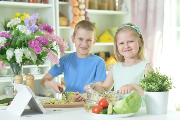 Cute little brother and sister cooking