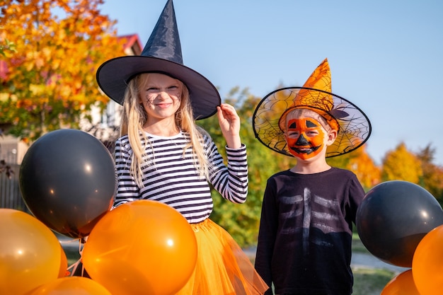 Cute little brother and sister in Halloween costumes