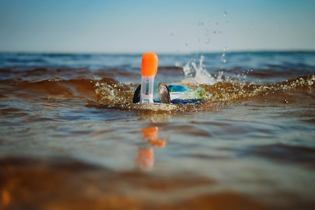 Cute little caucasian boy wearing snorkeling maskswimming in the sea