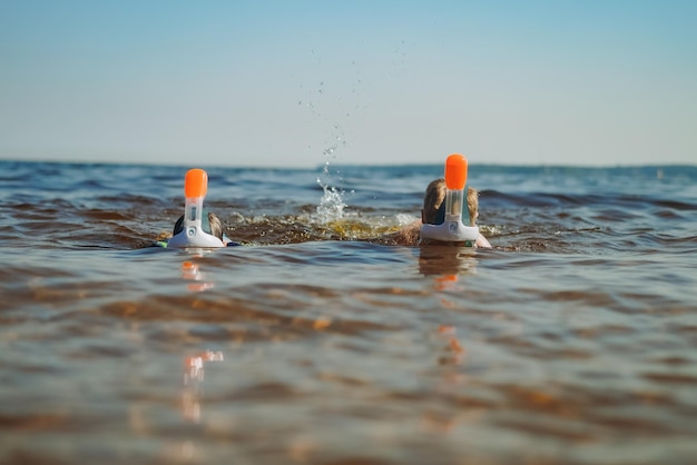 Cute little caucasian boys wearing snorkeling maskswimming in the sea