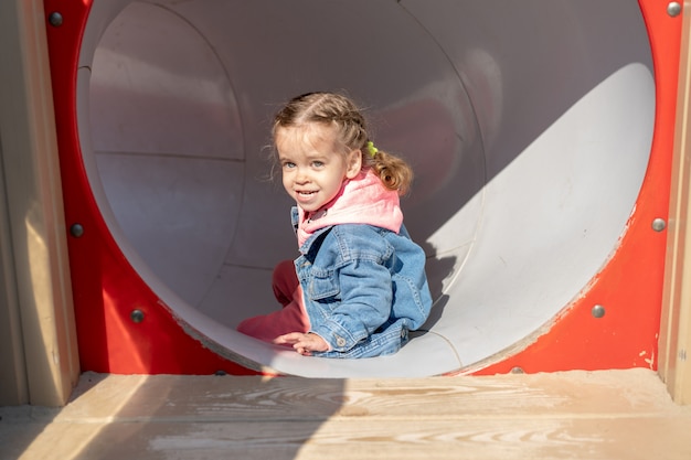 Cute little caucasian girl on the playground