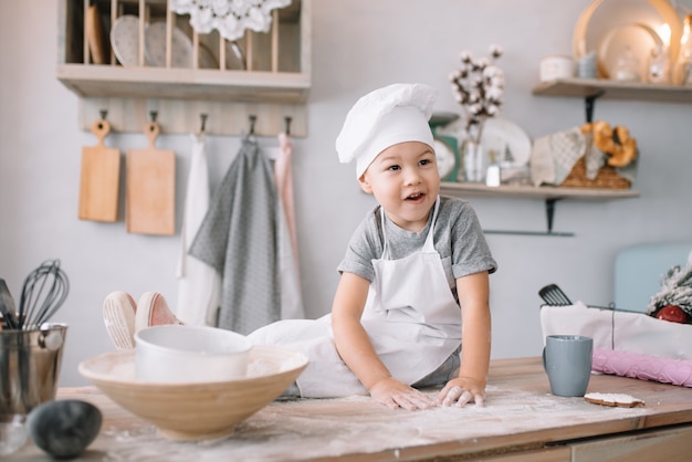 Cute little chef cooking in the kitchen