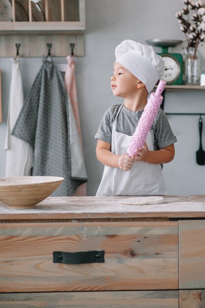 Cute little chef cooking in the kitchen