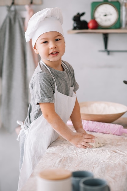 Cute little chef cooking in the kitchen