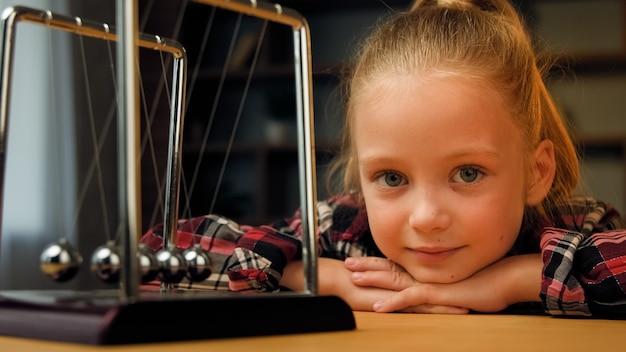 Cute little child toddler beautiful young restful school girl sit on psychotherapy session indoors