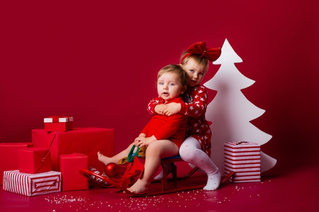 Cute little children on a sleigh at Christmas