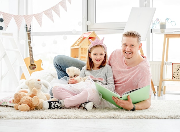 Cute little daughter with happy father