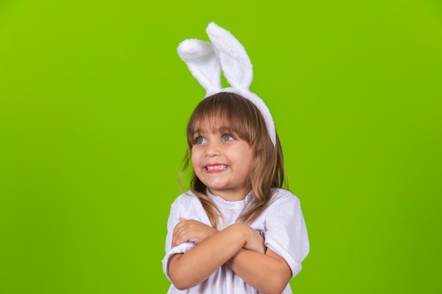 Cute little expressive girl with bunny ears for easter promotion