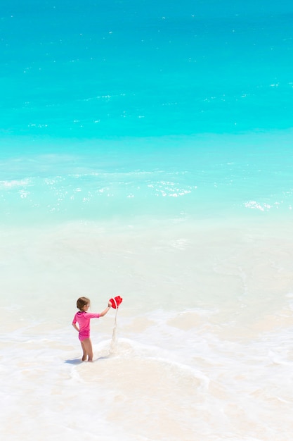 Cute little girl at beach during caribbean vacation