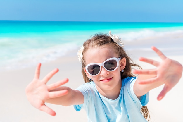 Cute little girl at beach during summer vacation