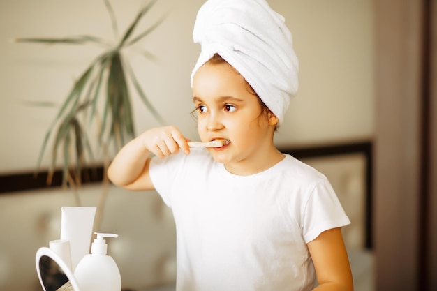 Photo cute little girl brushing teeth at home morning routine