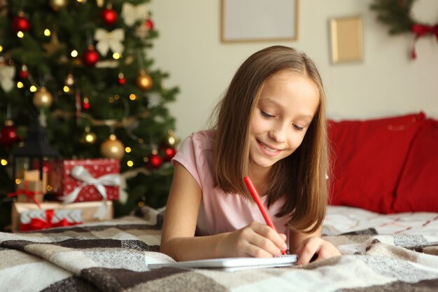 Cute little girl in the christmas interior of the house