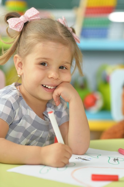 Cute little girl drawing with felt pen