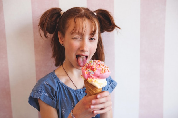 Cute little girl eating ice cream in cafeteria Child holding icecream Kid and sweets