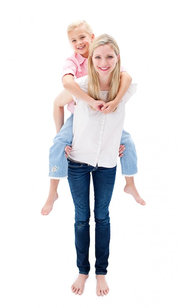 Cute little girl enjoying piggyback ride with her mother